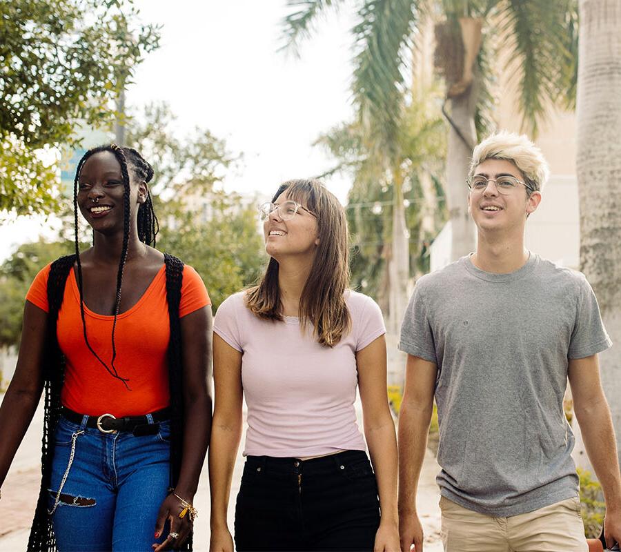 three PBA students program walk together on campus